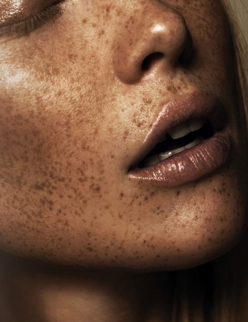 ultra close-up portrait of the lower half of a freckled woman's face