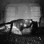 black & white picture of reclining woman on bed with starfield sheet
