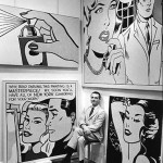 black & white photograph of Roy Lichtenstein seated before some of his works