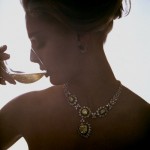 photograph of a woman wearing jewellery drinking wine