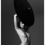 eniko mihalik nude holding a black umbrella over her head