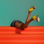 photograph of a woman's legs wearing yellow shoes