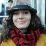photo of a woman on paris metro wearing hat, scarf and coat