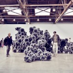 people looking at sculpture in art gallery