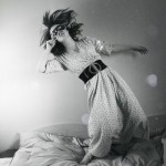 Masked woman falling on bed