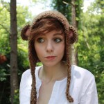Girl wearing a monkey hat in a forest