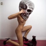 Skull masked woman and a black cat