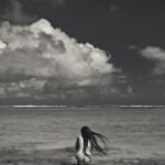 nude crouching near beach