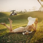 barefoot woman lounging on golf course
