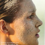 portrait of woman in profile with sand on her face