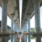 Pair of nude models under a bridge