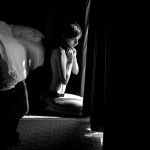woman sitting on floor in light through curtains