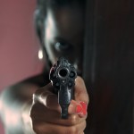 Woman pointing a gun