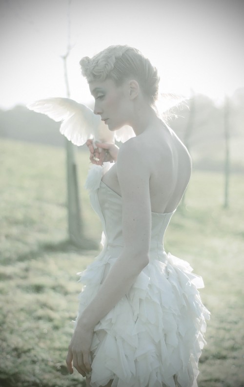 Katy Cee holding a white dove