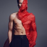 Marc Vanderloo shirtless with a piece of red fabric wind-blown against one side, by Txema Yeste