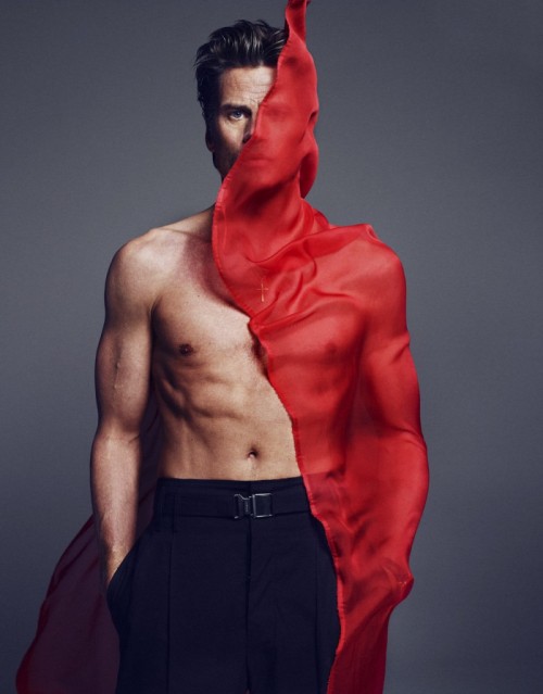 Marc Vanderloo shirtless with a piece of red fabric wind-blown against one side, by Txema Yeste