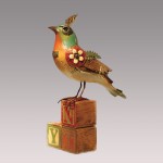 Bird with plume on vintage alphabet blocks