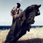 woman at seaside with gown blowing in the wind