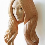 Cypress wood sculpture of a woman's head with detailed hair by Yasuhiro Sakurai