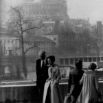 Hubert de Givenchy and Audrey Hepburn walking in Paris with Eiffel Tower in background