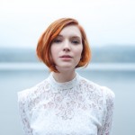 portrait of redhead woman in lace white dress by lisa lindoe