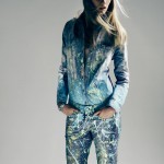 Woman in shirt and jeans with paint spatters