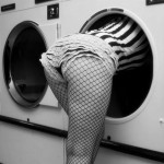 woman in lingerie halfway into washing machine