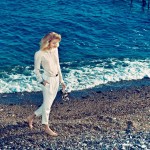 woman in white shirt and pantds on rocky beach