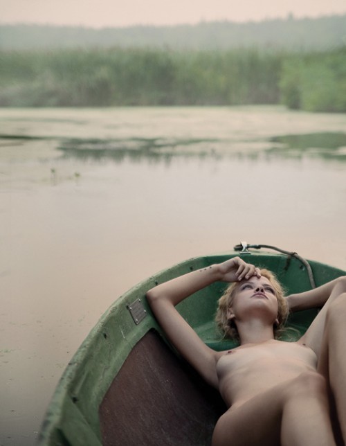 Nude lying in a row boat