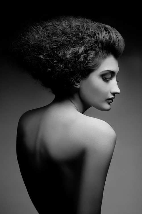 black & white profile picture of a nude woman taken from the back