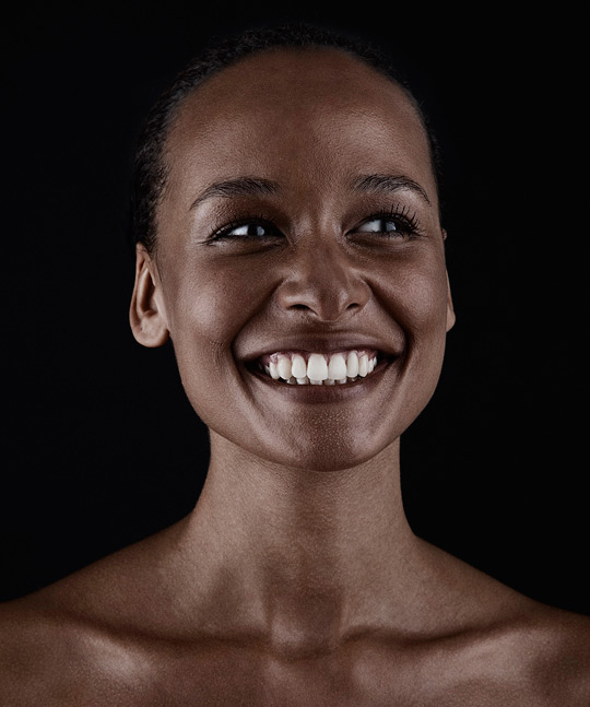 colour portrait of a smiling woman with dark brown skin