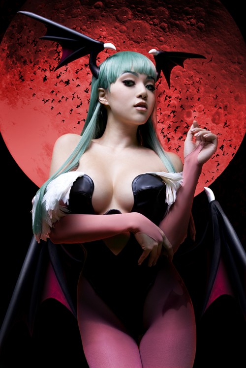photograph of a woman cosplaying as Morrigan from the video game Darkstalkers