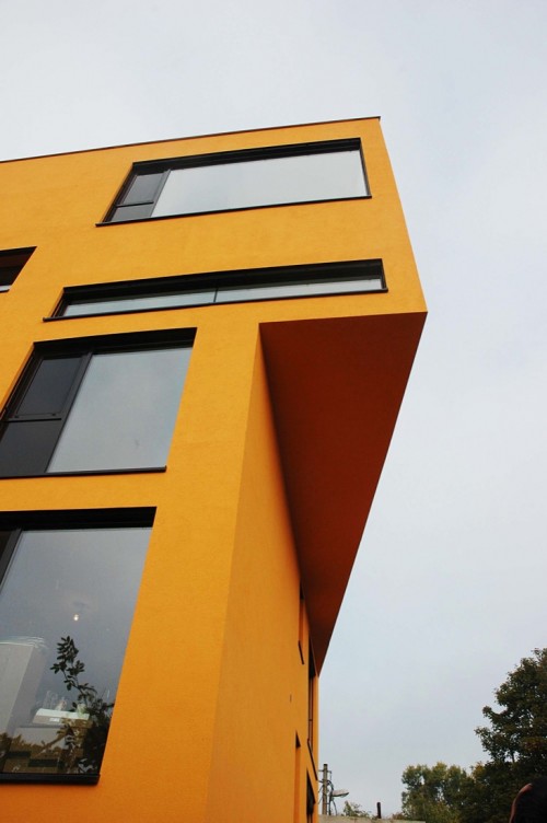 picture of the corner of an avant garde yellow building