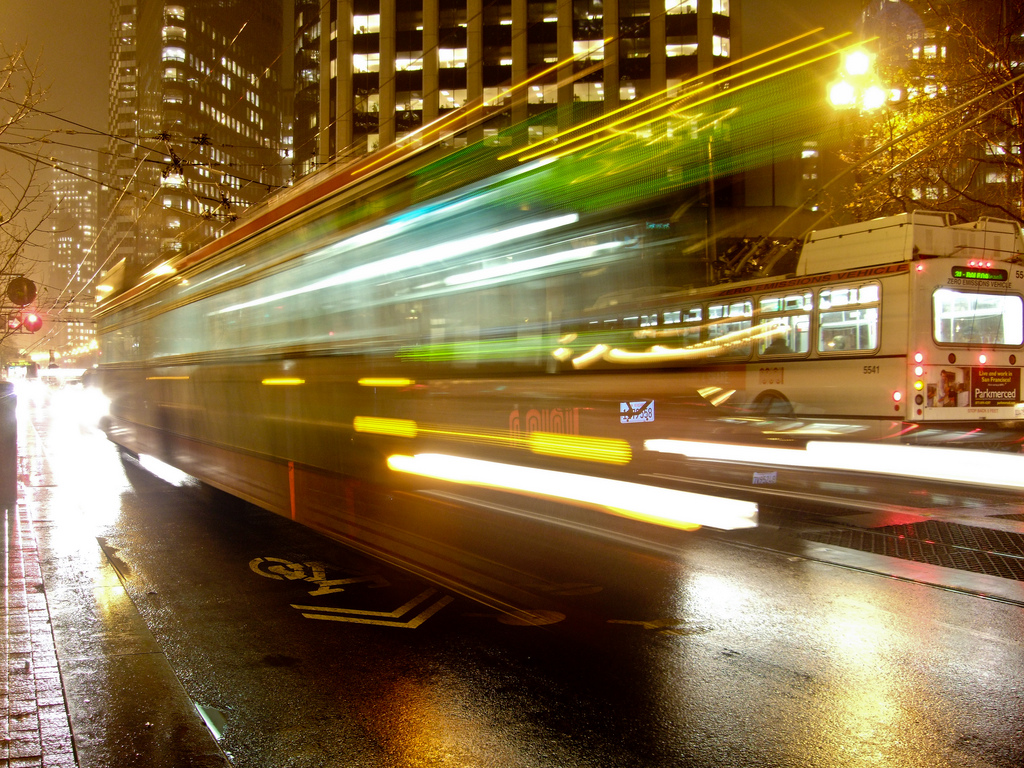long-exposure photograph of a blurry bus on a street