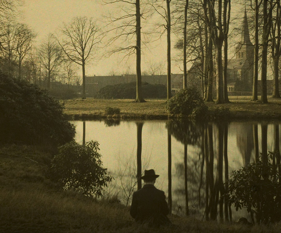 vintage photograph of a man sitting near a pond