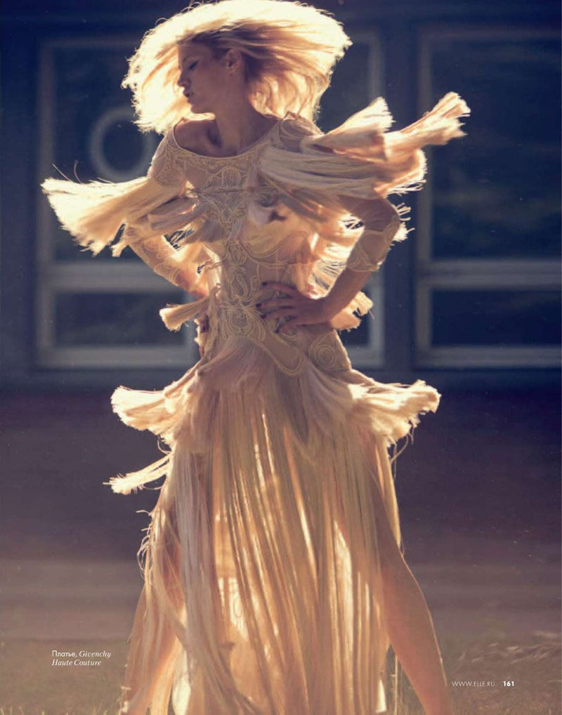 fashion shoot photo of a model turning wearing an elaborate dress