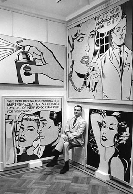 black & white photograph of Roy Lichtenstein seated before some of his works