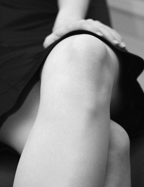 black & white close up photo of a woman's thighs