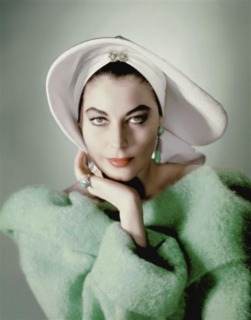 photograph of ava gardner in a white hat and green coat