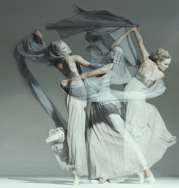 photograph of dancers in flowing grey and white dresses