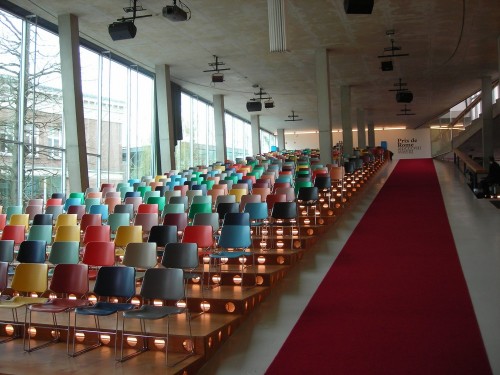 photograph of an auditorium with colourful chairs