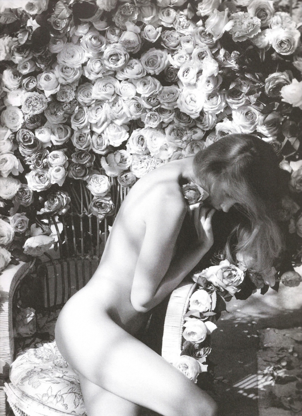 edita vilkeviciute nude on a chair in front of flowers