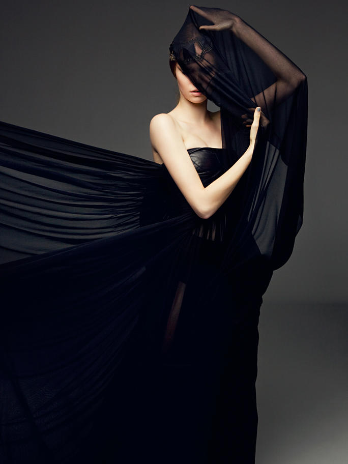 picture of a woman in flowing black dress with face obscured