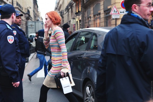 photo of a woman with red hair crossing a street
