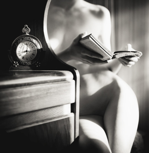 nude woman reading a book