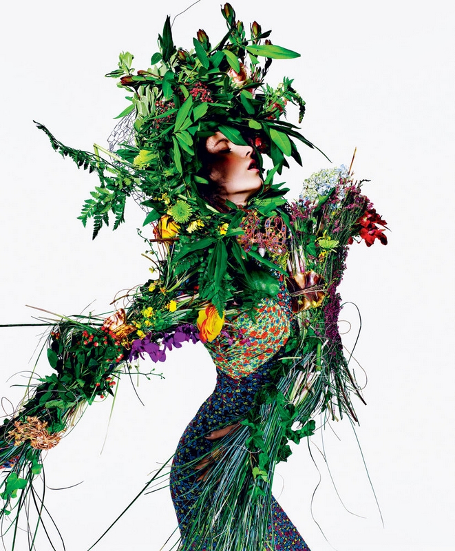 woman dressed in leaves and plants
