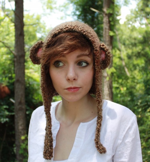 Girl wearing a monkey hat in a forest