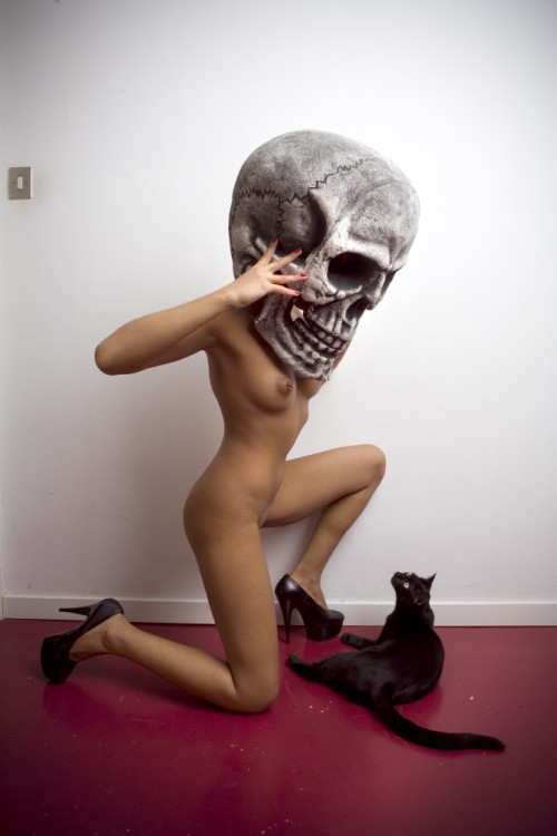 Skull masked woman and a black cat