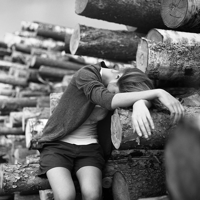 Girl and tree trunks by Aleksey Chizhik