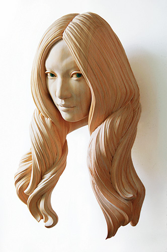 Cypress wood sculpture of a woman's head with detailed hair by Yasuhiro Sakurai